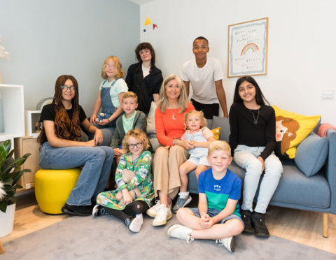 Children First CEO Mary Glasgow and children sit in the recovery room of the first Bairns Hoose