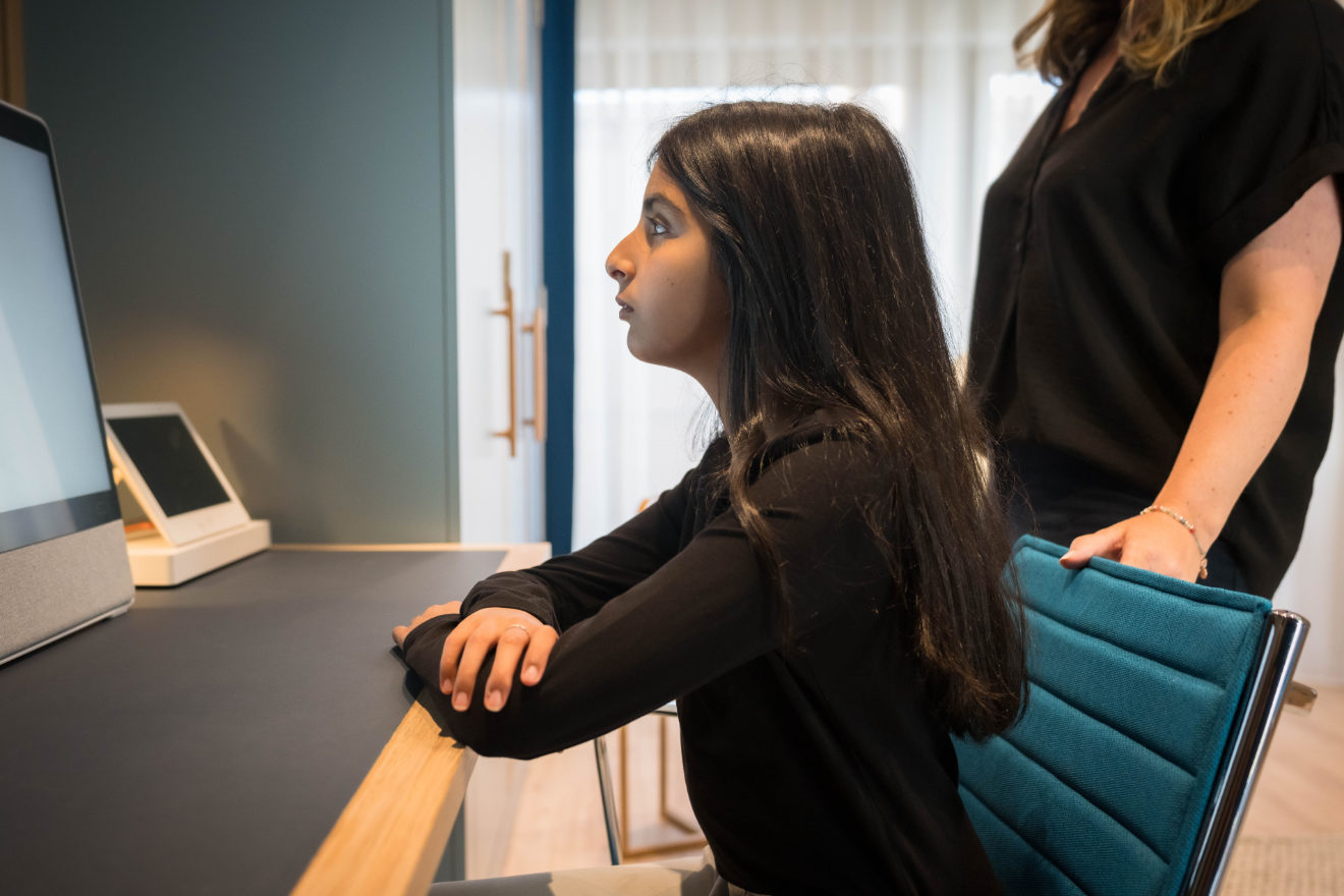Child looking at a computer monitor